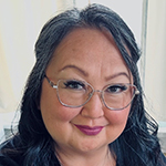 headshot of chief grace george wearing glasses and smiling